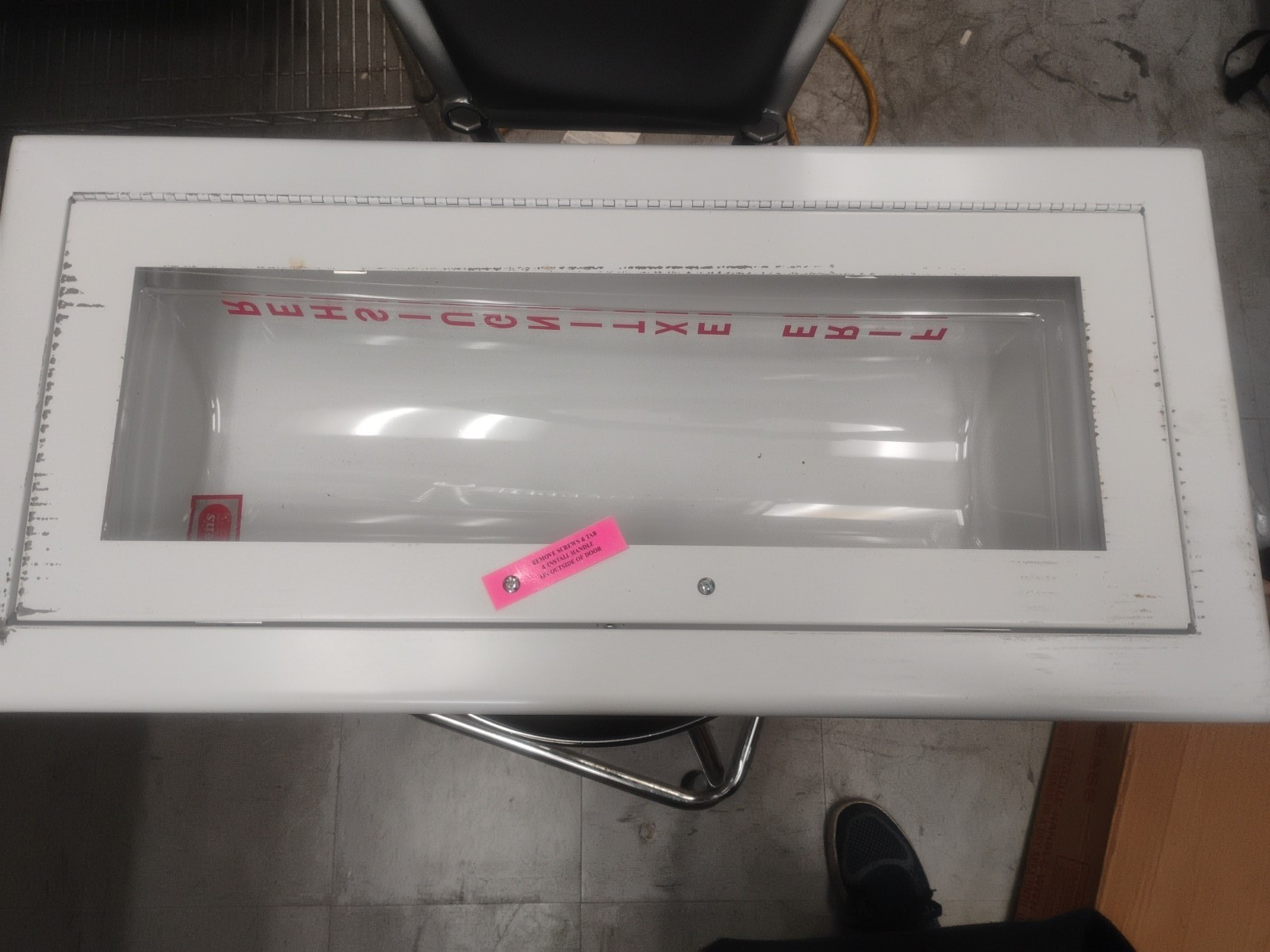 white fire extinguisher cabinet with a breakable glass panel
